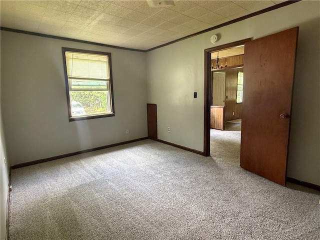 303 Bell St, Richmond, MO 64085 - carpeted spare room with ornamental molding and a smoke detector
