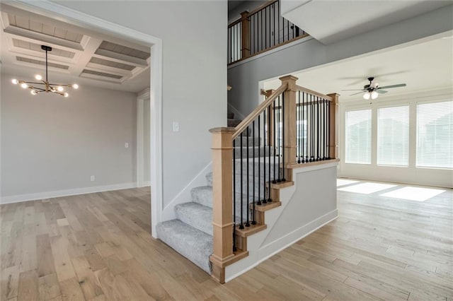 16941 S Brentwood St, Olathe, KS 66062 - staircase featuring coffered ceiling, wood finished floors, a chandelier, ceiling fan, and beam ceiling