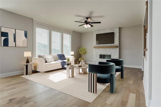 16941 S Brentwood St, Olathe, KS 66062 - living area featuring ceiling fan, light wood finished floors, and a fireplace