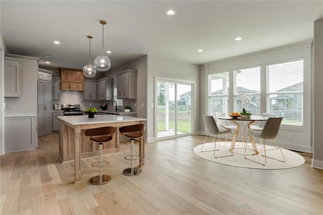 16941 S Brentwood St, Olathe, KS 66062 - kitchen with stainless steel electric stove, gray cabinets, light countertops, light wood-type flooring, and a center island