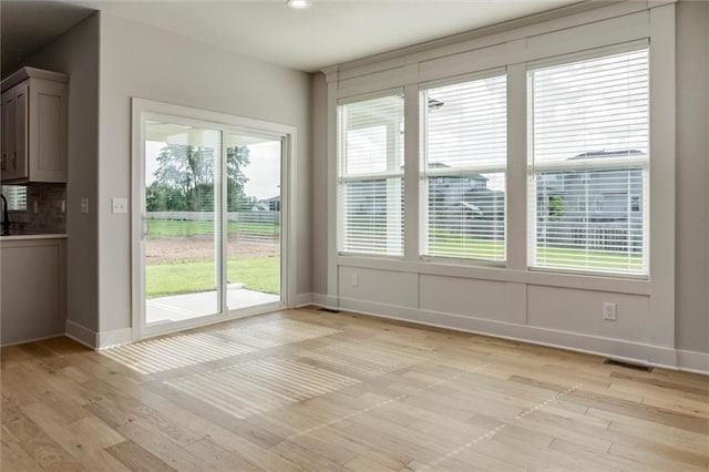 16941 S Brentwood St, Olathe, KS 66062 - unfurnished dining area with light wood-type flooring and recessed lighting