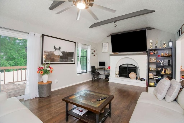 7921 Yecker St, Kansas City, KS 66102 - living room featuring lofted ceiling, a ceiling fan, a fireplace, and wood finished floors