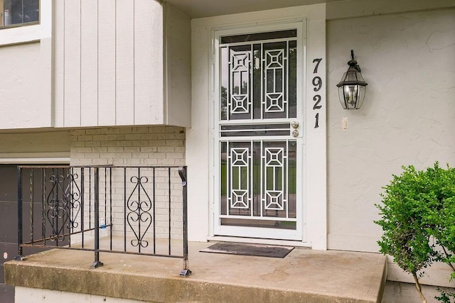 7921 Yecker St, Kansas City, KS 66102 - view of exterior entry with stucco siding and brick siding