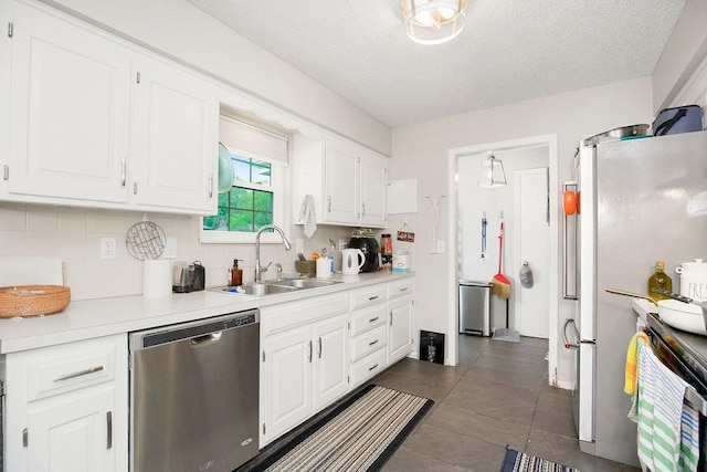 7921 Yecker St, Kansas City, KS 66102 - kitchen featuring dishwasher, backsplash, white cabinetry, and a textured ceiling