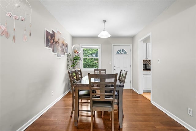 13211 Craig Ave, Grandview, MO 64030 - dining room with dark wood-style floors and baseboards