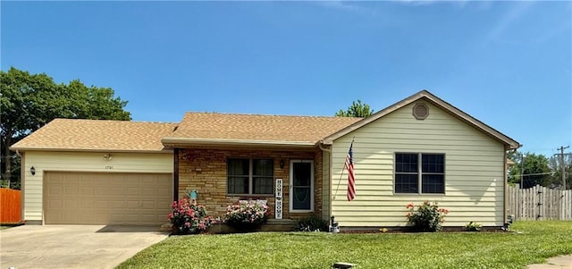 1701 S Maple St, Ottawa, KS 66067 - ranch-style house with an attached garage and driveway
