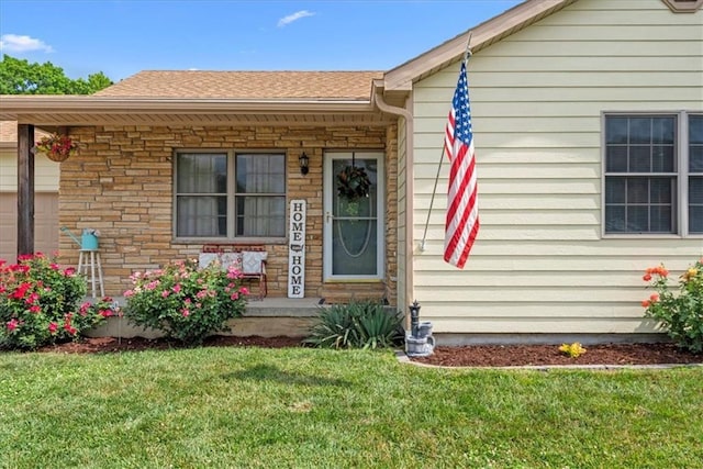 1701 S Maple St, Ottawa, KS 66067 - entrance to property featuring a lawn, covered porch, stone siding, and a shingled roof