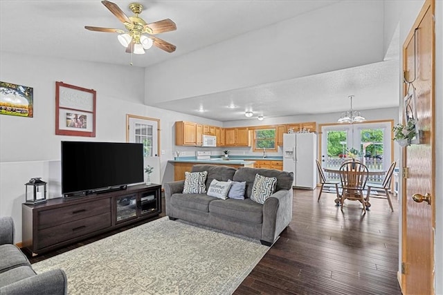 1701 S Maple St, Ottawa, KS 66067 - living room with ceiling fan, lofted ceiling, dark wood-type flooring, and a chandelier