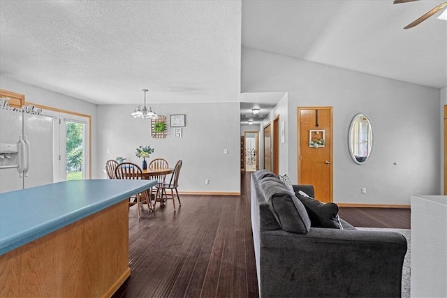 1701 S Maple St, Ottawa, KS 66067 - living room with dark wood-style flooring, a ceiling fan, a chandelier, and vaulted ceiling