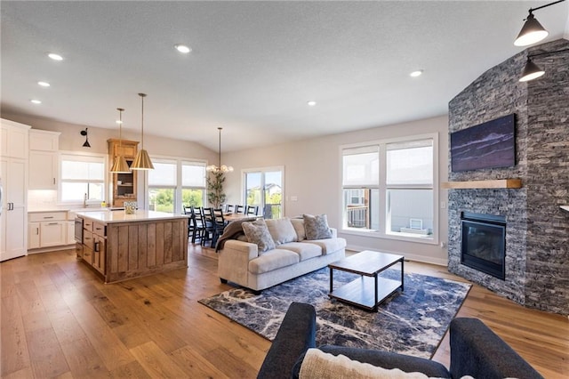 19013 W 188th Ter, Spring Hill, KS 66083 - living area featuring hardwood / wood-style flooring, plenty of natural light, recessed lighting, a fireplace, and lofted ceiling