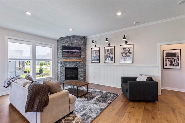 19013 W 188th Ter, Spring Hill, KS 66083 - living room featuring ornamental molding, a fireplace, wood finished floors, and wainscoting