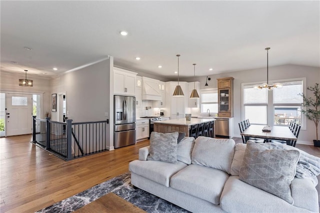 19013 W 188th Ter, Spring Hill, KS 66083 - living area featuring a chandelier, wood finished floors, and recessed lighting