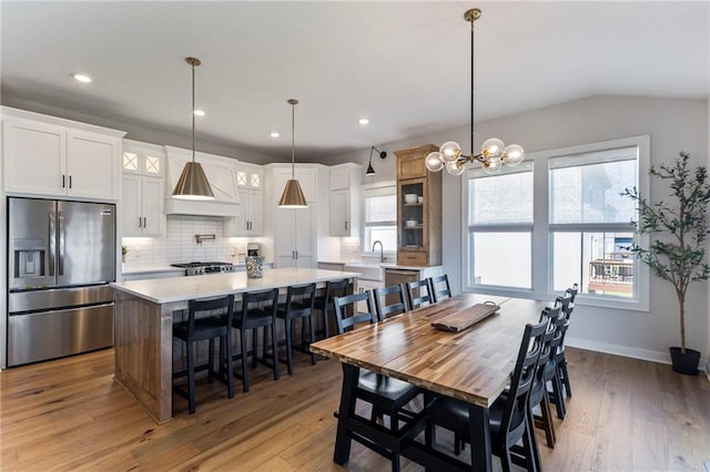 19013 W 188th Ter, Spring Hill, KS 66083 - dining room with light wood-style flooring, recessed lighting, a chandelier, and lofted ceiling