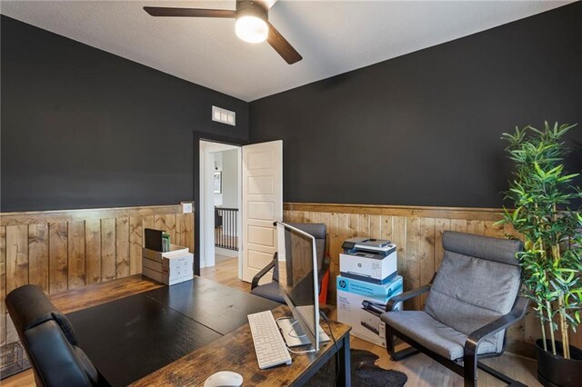 19013 W 188th Ter, Spring Hill, KS 66083 - home office with a wainscoted wall, wood walls, ceiling fan, and wood finished floors