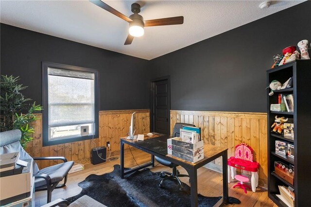 19013 W 188th Ter, Spring Hill, KS 66083 - office area with wainscoting, wood walls, ceiling fan, and wood finished floors
