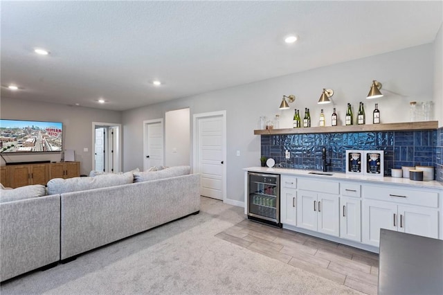 19013 W 188th Ter, Spring Hill, KS 66083 - living room with beverage cooler, bar with sink, recessed lighting, and light wood-style flooring