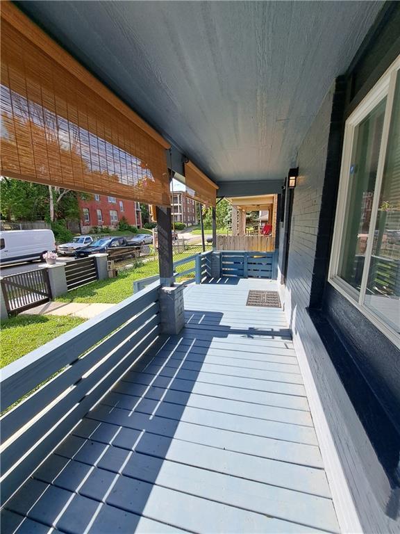 3009 Montgall Ave, Kansas City, MO 64128 - view of wooden porch