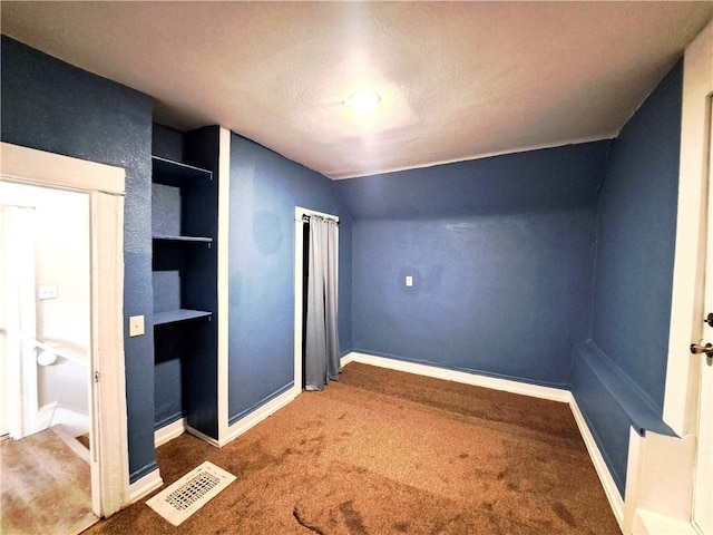 3009 Montgall Ave, Kansas City, MO 64128 - unfurnished bedroom featuring a textured ceiling, carpet floors, and vaulted ceiling