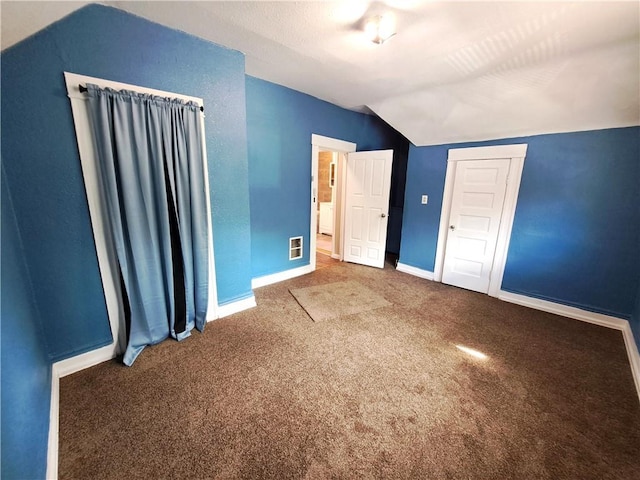 3009 Montgall Ave, Kansas City, MO 64128 - unfurnished bedroom featuring vaulted ceiling, carpet floors, and a closet