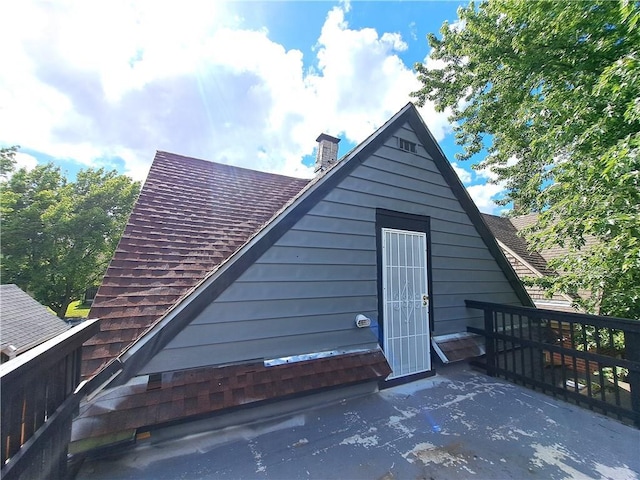 3009 Montgall Ave, Kansas City, MO 64128 - back of house featuring a chimney and a shingled roof