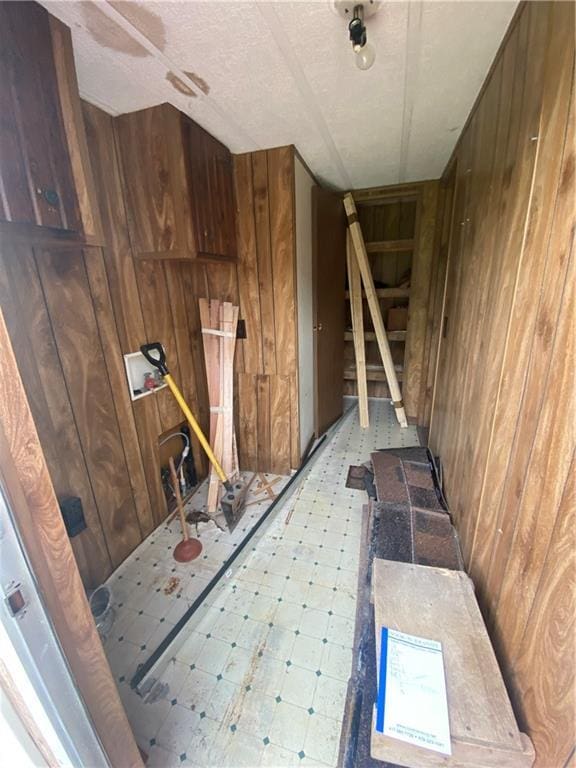 101 E Vine St, Arcadia, KS 66711 - stairs featuring wood walls and tile patterned floors