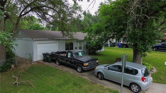 1736 Brook St, Lawrence, KS 66044 - view of front of house featuring an attached garage, concrete driveway, a front lawn, and roof with shingles