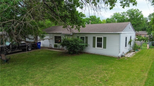 1736 Brook St, Lawrence, KS 66044 - back of property featuring an attached garage and a shingled roof