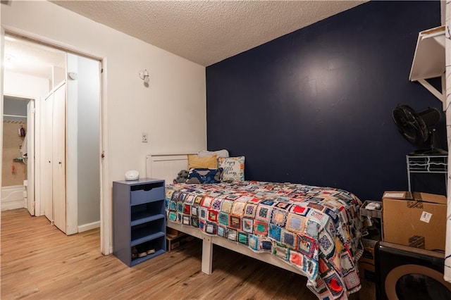 1736 Brook St, Lawrence, KS 66044 - bedroom with wood finished floors and a textured ceiling
