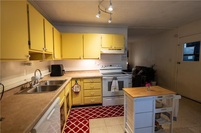 1736 Brook St, Lawrence, KS 66044 - kitchen with white appliances, under cabinet range hood, wood counters, dark tile patterned floors, and cream cabinetry