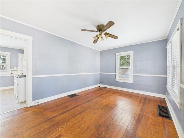 411 S Bismark, Concordia, MO 64020 - empty room featuring plenty of natural light, a ceiling fan, hardwood / wood-style floors, and ornamental molding