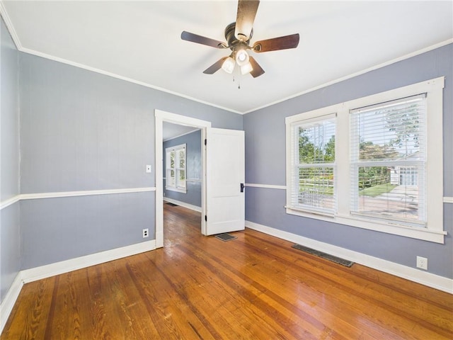 411 S Bismark, Concordia, MO 64020 - spare room with healthy amount of natural light, a ceiling fan, wood finished floors, and crown molding