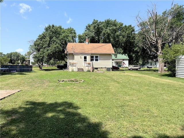 411 S Bismark, Concordia, MO 64020 - back of property featuring a lawn and a chimney