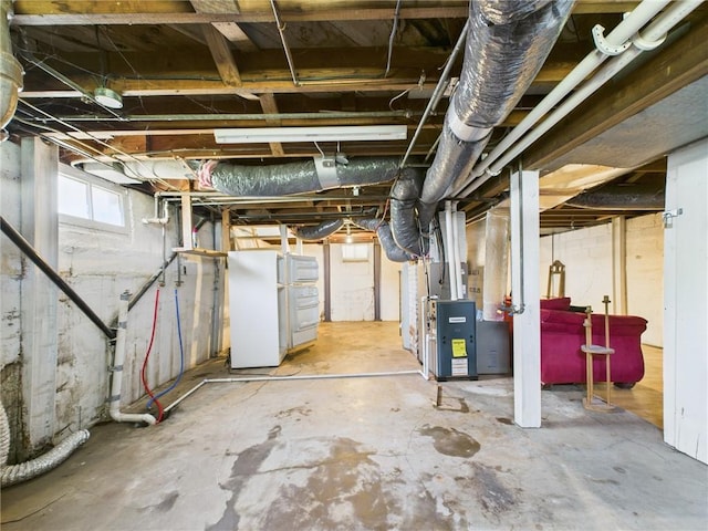 411 S Bismark, Concordia, MO 64020 - basement with heating unit and freestanding refrigerator