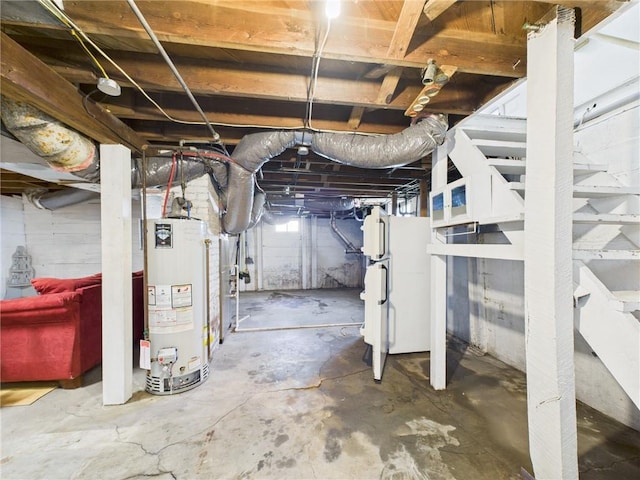 411 S Bismark, Concordia, MO 64020 - unfinished basement with gas water heater and freestanding refrigerator