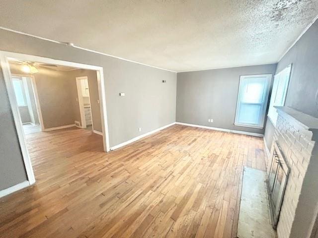 5046 Glenside Ct, Kansas City, MO 64129 - spare room with light wood-type flooring, healthy amount of natural light, and a textured ceiling