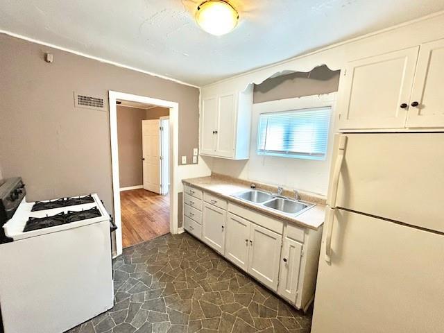 5046 Glenside Ct, Kansas City, MO 64129 - kitchen with white appliances, white cabinetry, and light countertops