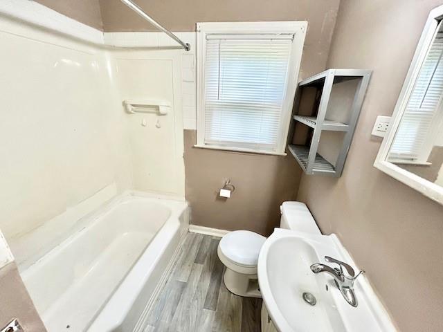 5046 Glenside Ct, Kansas City, MO 64129 - bathroom with wood finished floors, shower / bath combination, and vanity
