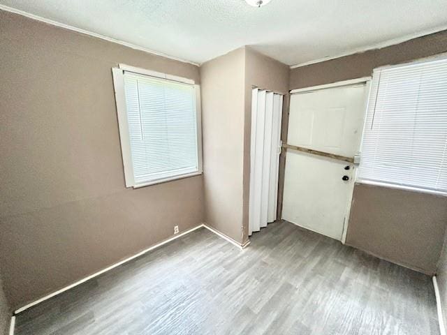 5046 Glenside Ct, Kansas City, MO 64129 - unfurnished bedroom featuring wood finished floors and a closet