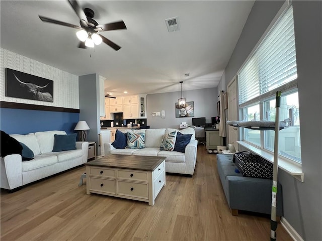 11681 S Roundtree St, Olathe, KS 66061 - living area featuring ceiling fan and light wood-style flooring