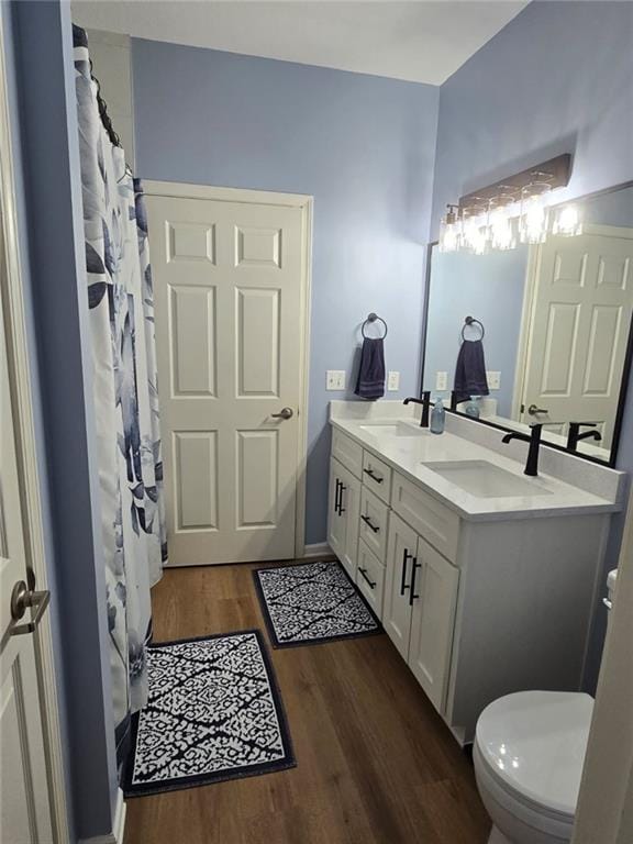 11681 S Roundtree St, Olathe, KS 66061 - bathroom featuring double vanity and wood finished floors