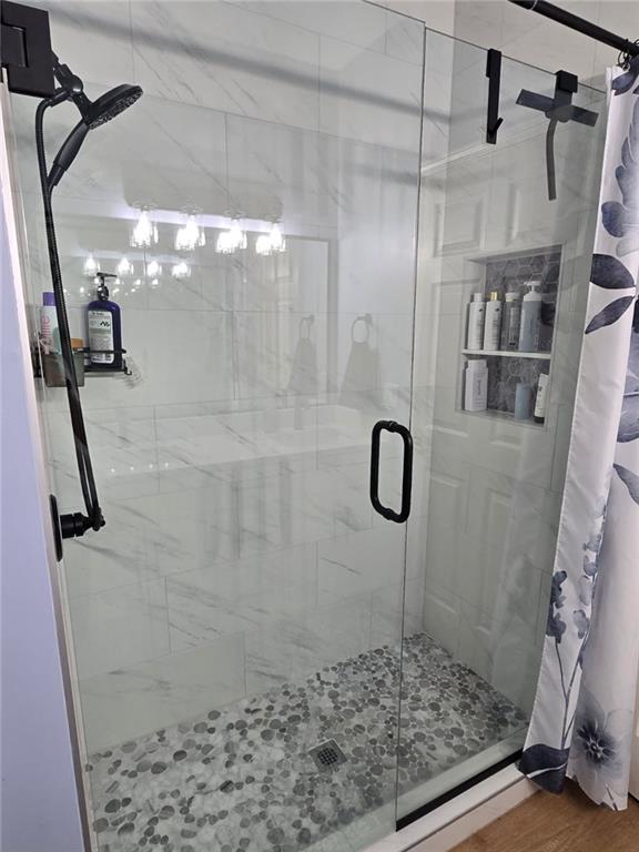 11681 S Roundtree St, Olathe, KS 66061 - full bathroom with a stall shower and wood finished floors