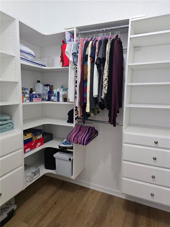11681 S Roundtree St, Olathe, KS 66061 - walk in closet with dark wood-type flooring