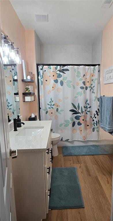11681 S Roundtree St, Olathe, KS 66061 - bathroom with vanity, wood finished floors, and shower / bath combination with curtain