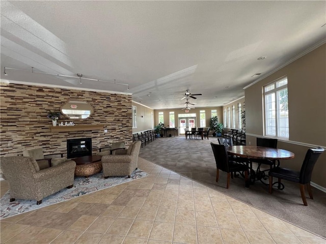 11681 S Roundtree St, Olathe, KS 66061 - carpeted dining space with plenty of natural light, a fireplace, tile patterned floors, and ornamental molding