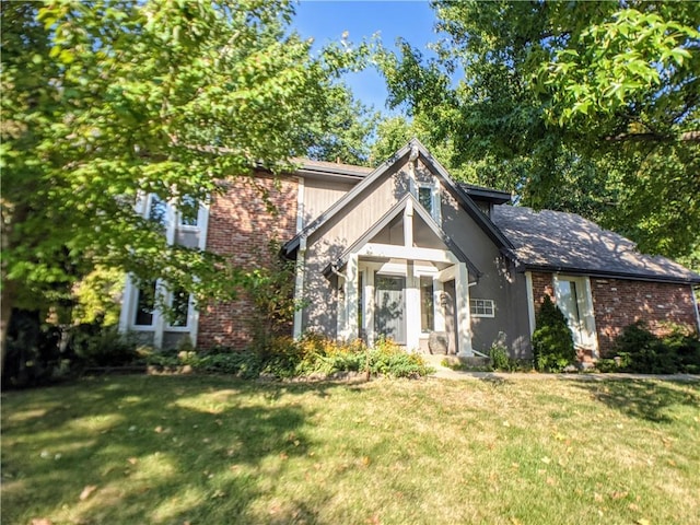 10122 Earnshaw St, Lenexa, KS 66215 - view of front of property with a front yard and brick siding