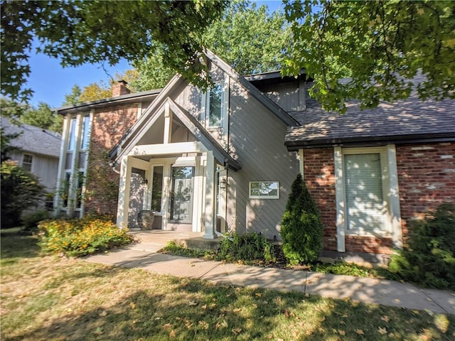 10122 Earnshaw St, Lenexa, KS 66215 - view of front of property with a chimney and brick siding