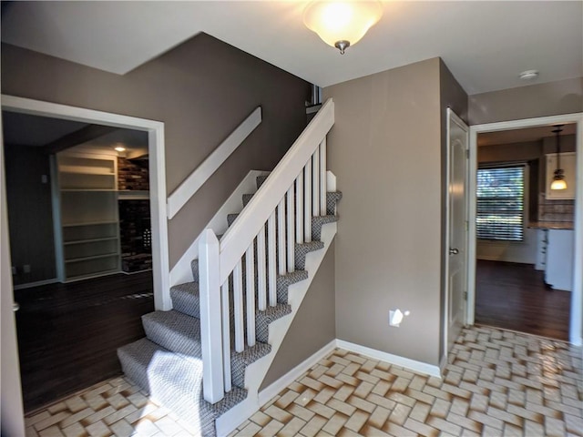 10122 Earnshaw St, Lenexa, KS 66215 - staircase with baseboards and wood finished floors