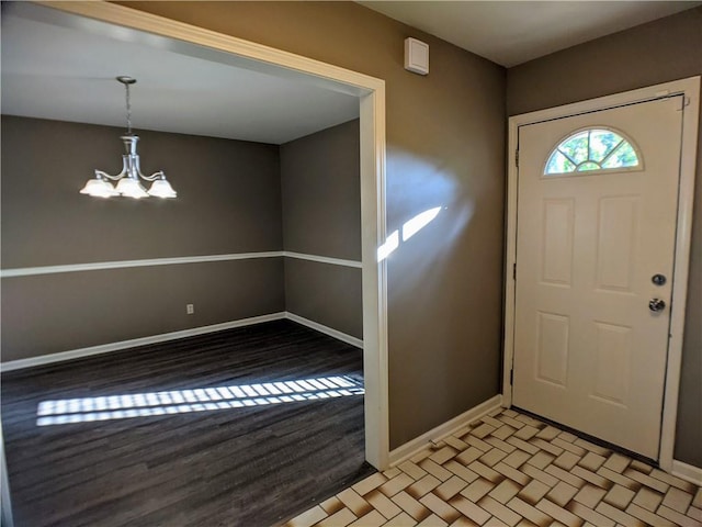 10122 Earnshaw St, Lenexa, KS 66215 - entrance foyer featuring a chandelier and light wood-style flooring