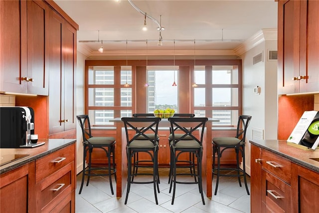 2510 Grand Blvd Unit 2502-03, Kansas City, MO 64108 - dining space with crown molding, light tile patterned flooring, plenty of natural light, and track lighting
