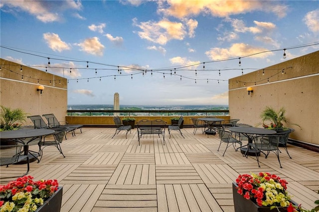2510 Grand Blvd Unit 2502-03, Kansas City, MO 64108 - wooden deck with outdoor dining space and a water view